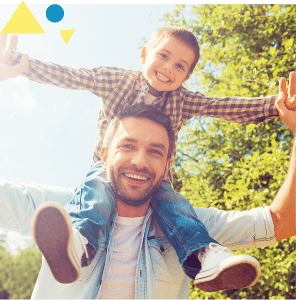 young boy and father smiling