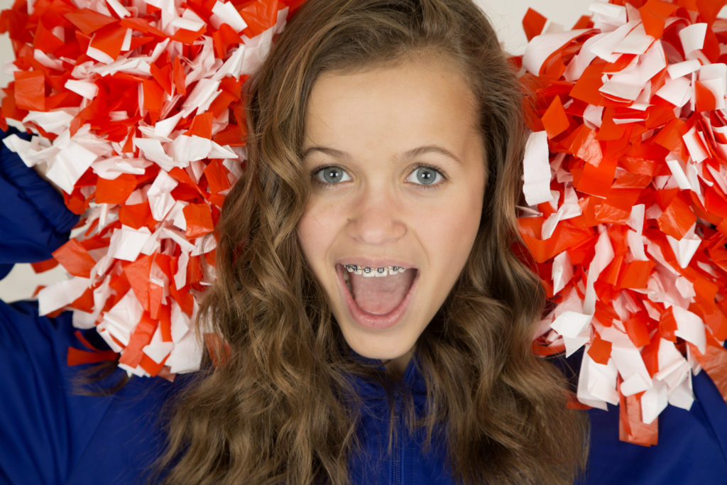 Teenage cheerleader girl wearing braces