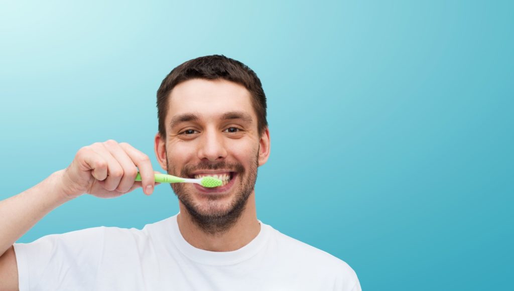 man brushing his teeth